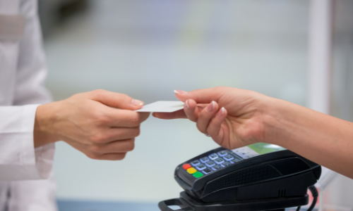 Customer handing a cashier a gift card